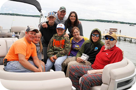Donovan Johnson and his family on a pontoon boat to fish.
