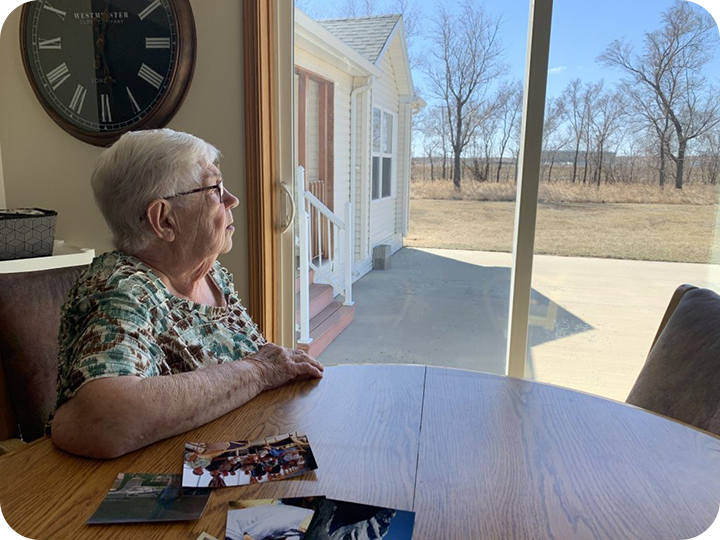 Sharon looking out the window at her farm.