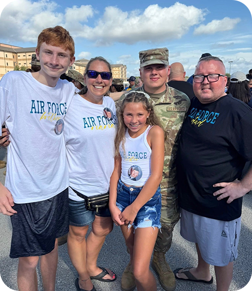 Brad and Sara Schenck smiling with their children.