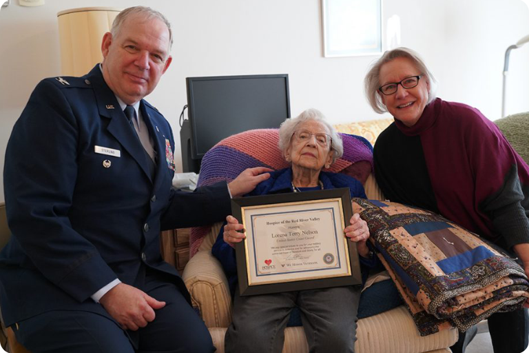 Jim Sterling, with Hospice of the Red River Valley, Terry and her daughter Pat during a ceremony recognizing Terry’s military service.