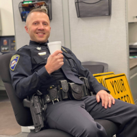 Brad Schenck in his police uniform smiling.